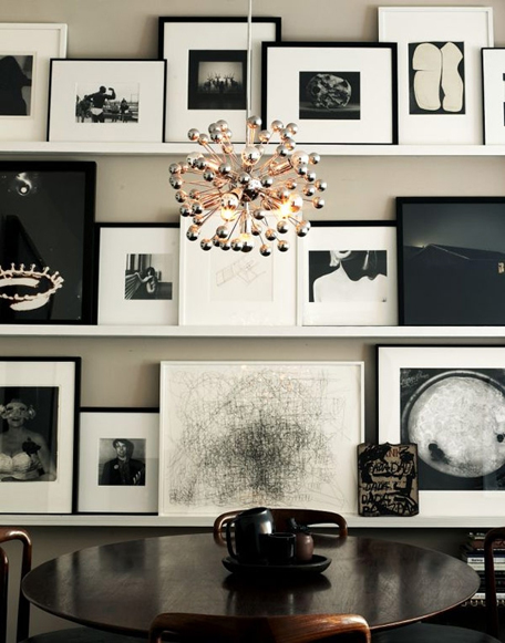 Instead of hanging the wall art on the wall, create ledges, to allow for regular changes to your collage. In this case, a black and white themed wall art collage creates a sleek and retro feel. 
