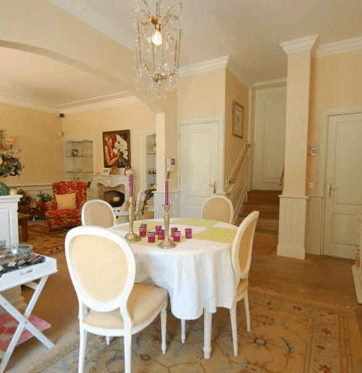 The main floor boasts a wonderful formal living room and eat-in kitchen with doors leading to the garden